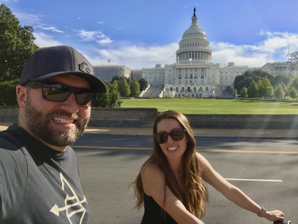 Ryan and Katy biking in front of the U.S. Capitol Building