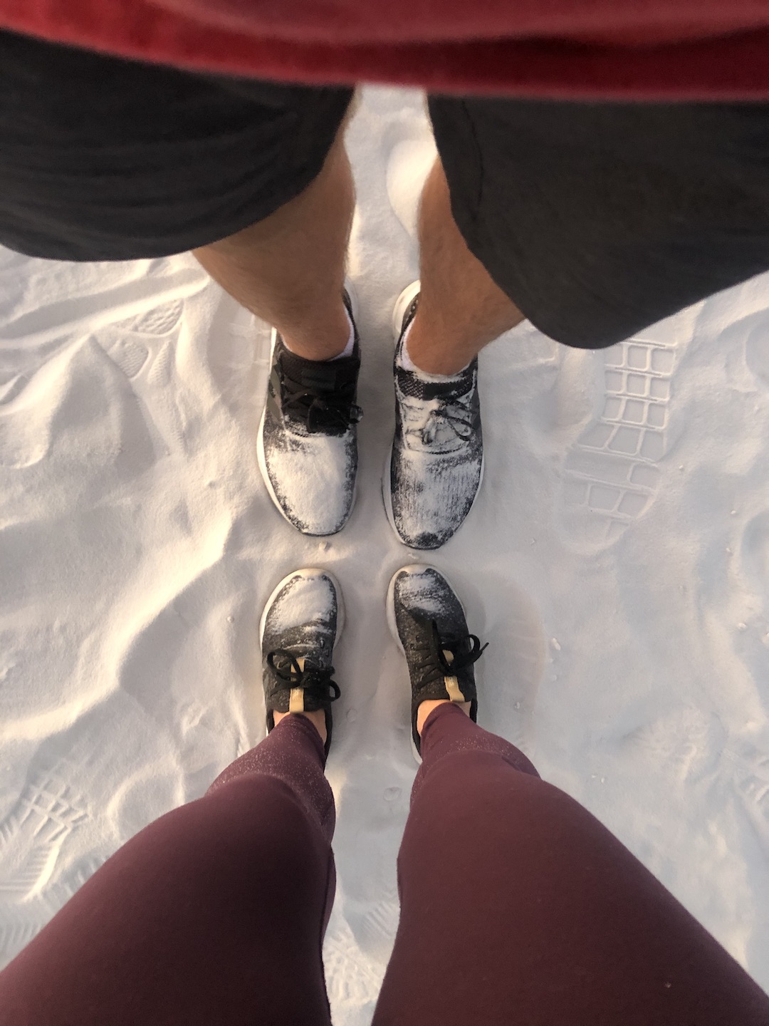White sand on Ryan and Katy's feet